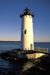 Sun Setting By Lighthouse in New England